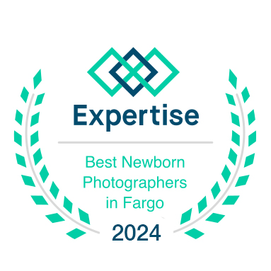 Award badge for 'Best Newborn Photographers in Fargo 2024' by Expertise.